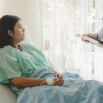 female patient lying in bed